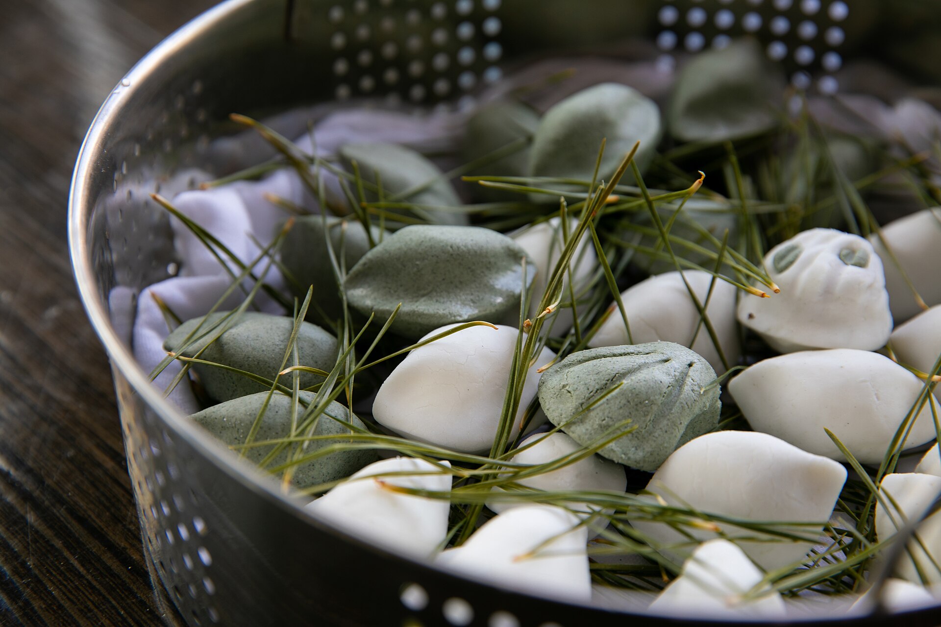 White and green songpyeon steamed on pine needles