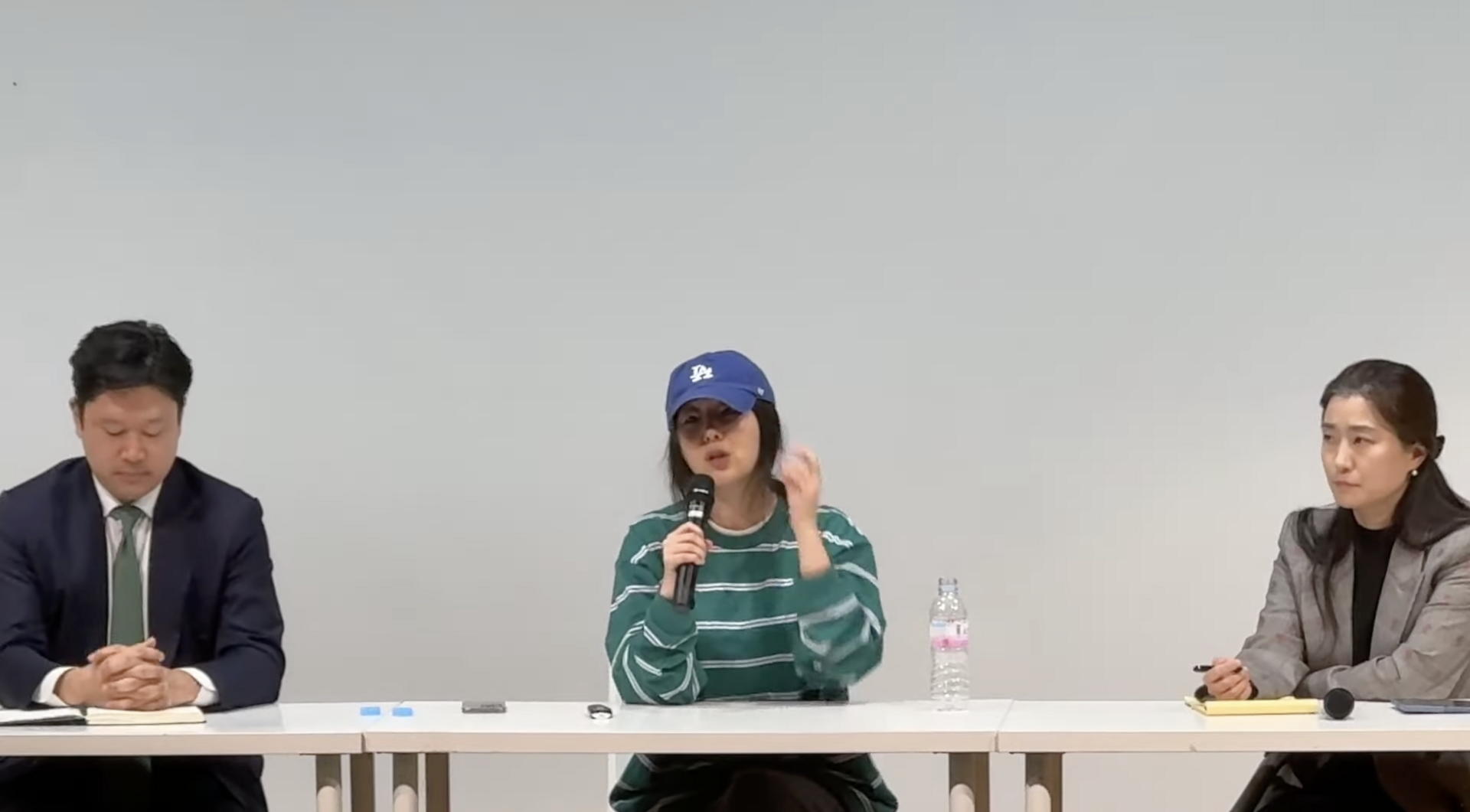 Min Hee-jin seated at a microphone at a press conference