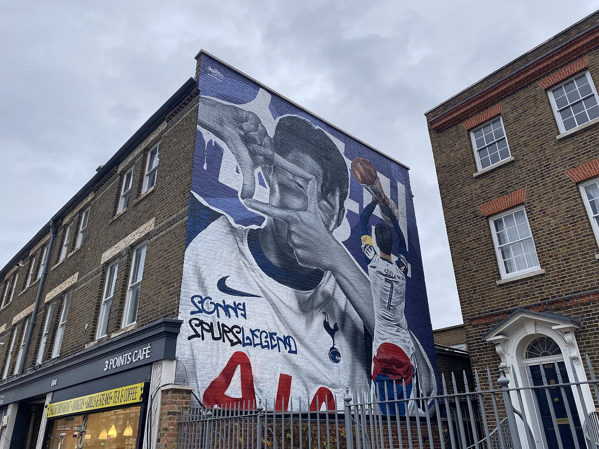 A large mural of Son Heung-min on the side of a London street building